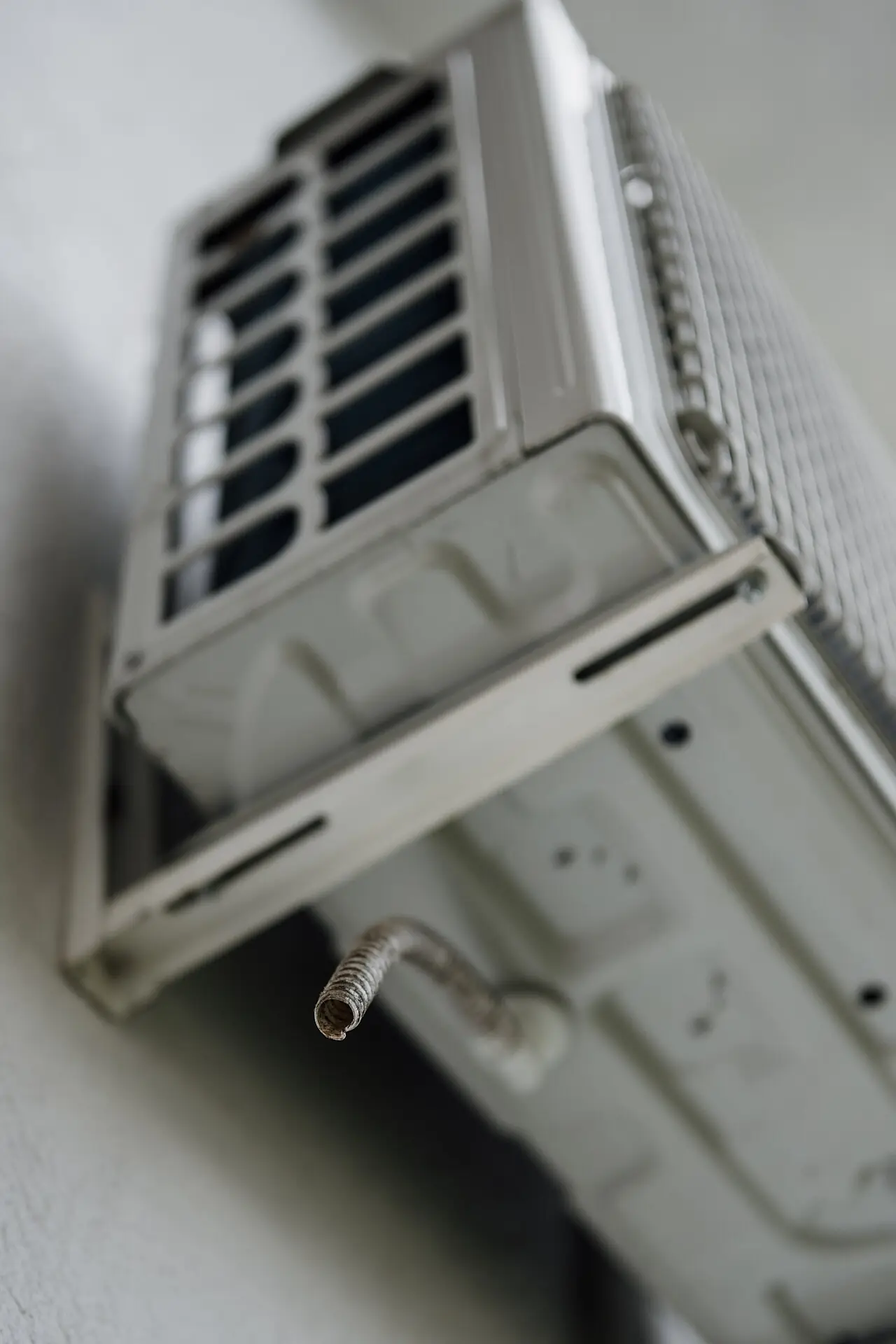 Wall-mounted air-conditioning unit with the line set visible